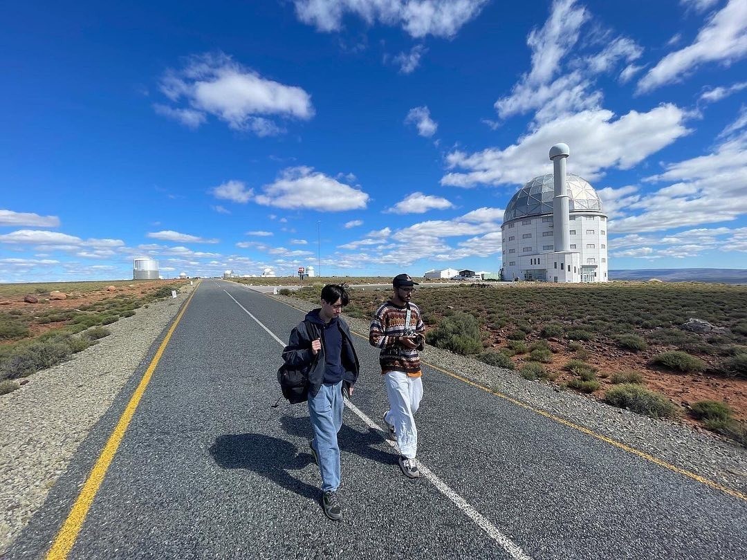 Kamil Hassim and Ian Purnell walking by the SALT Telescope