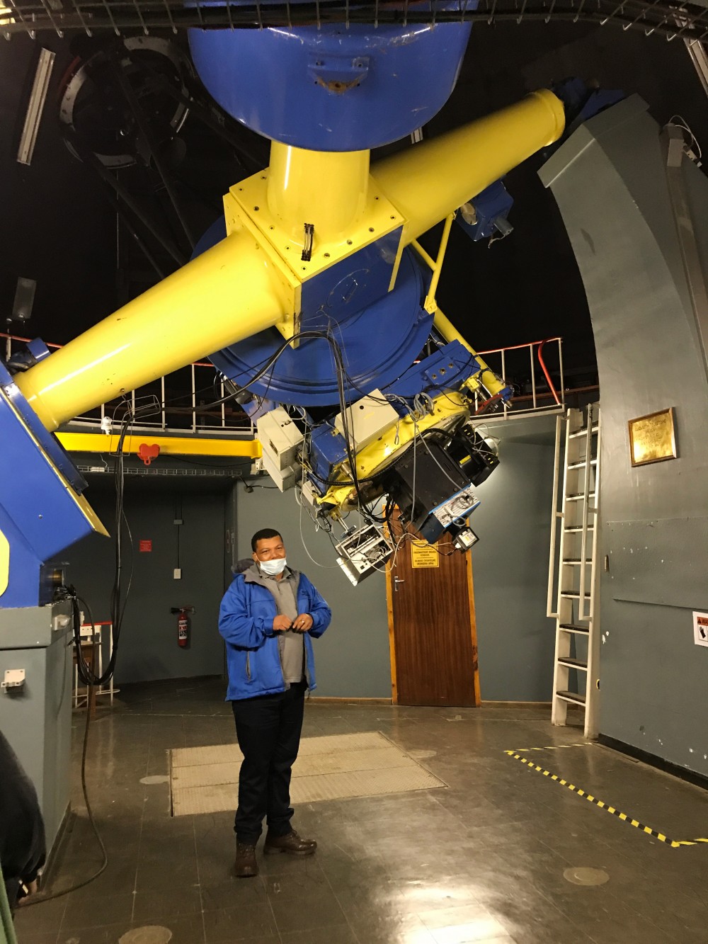An astronomer at SAAO showing the 1.0 metre telescope