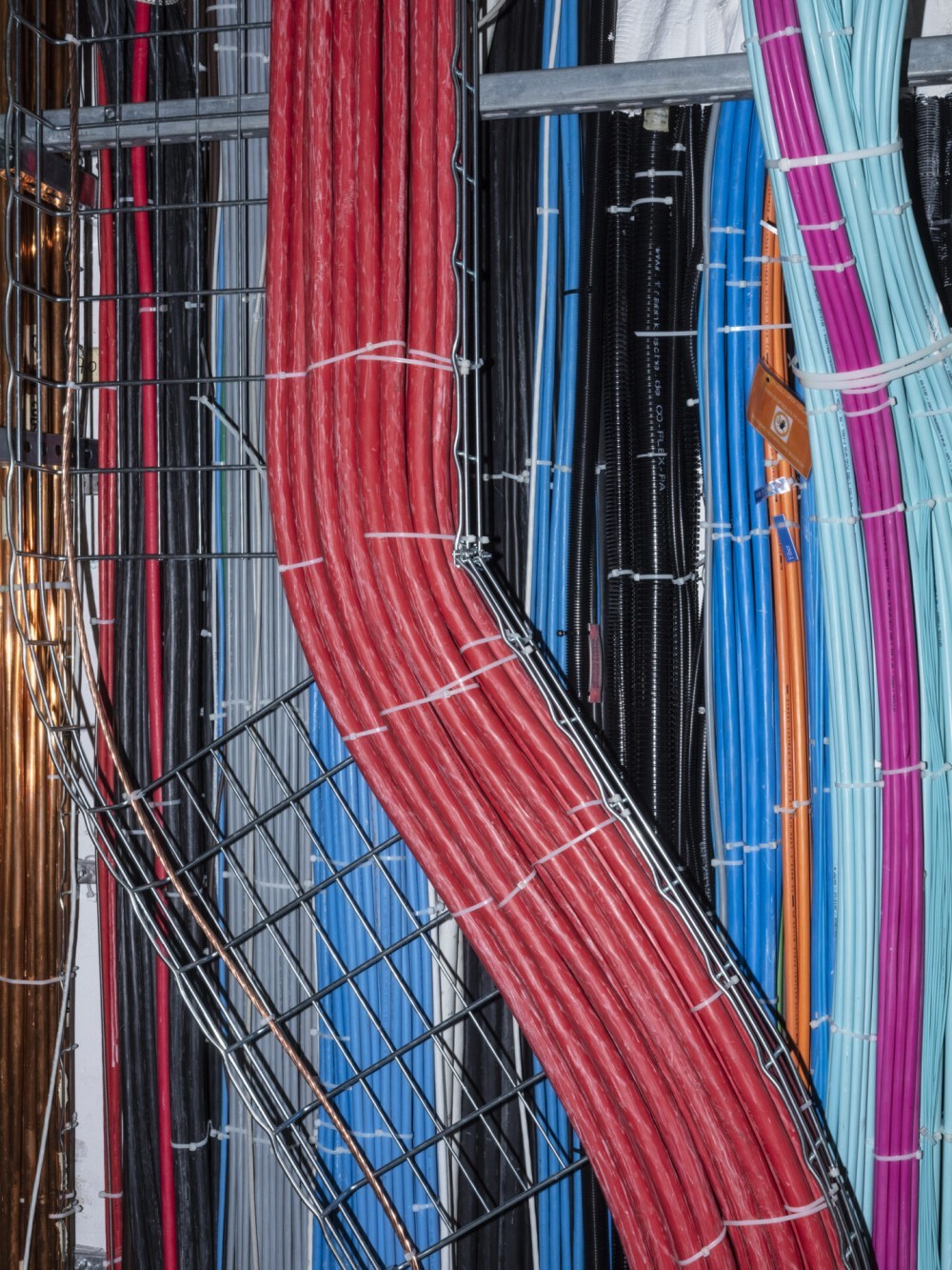 Sensor cabling of bright colours at the  Large Hadron Collider. Photo by Armin Linke