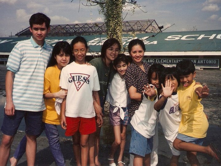 The artist, on the far right, posing with family members in front of what-was-once an elementary school buried under dried lahar (volcanic mudflow), two yearsafter the Mount Pinatubo eruption. San Antonio, Pampanga, Philippines, 1993. Courtesy the artist.